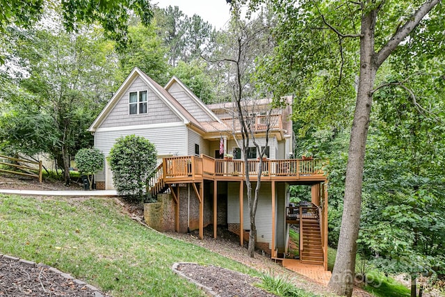 rear view of property featuring a yard and a deck