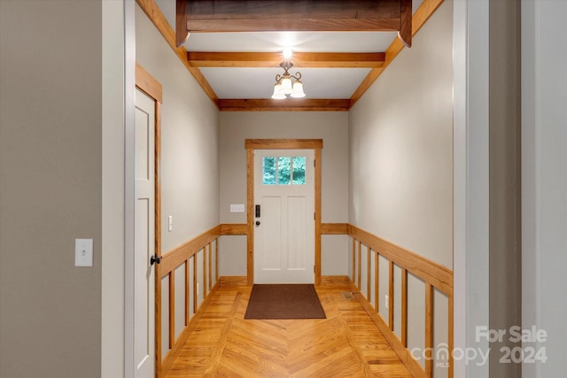 doorway to outside with an inviting chandelier and light parquet floors