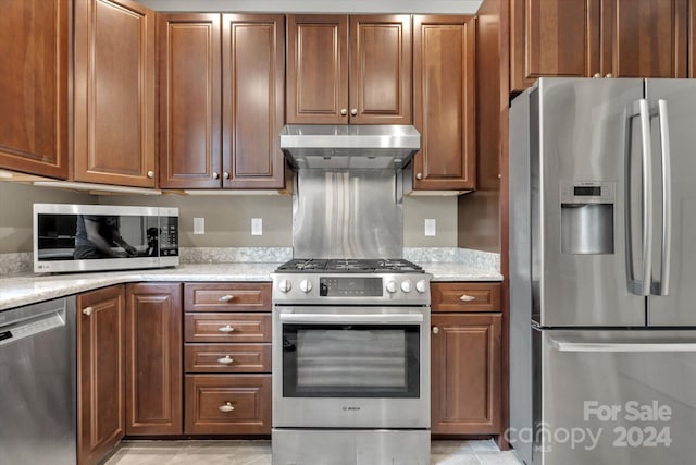 kitchen featuring appliances with stainless steel finishes and light stone countertops