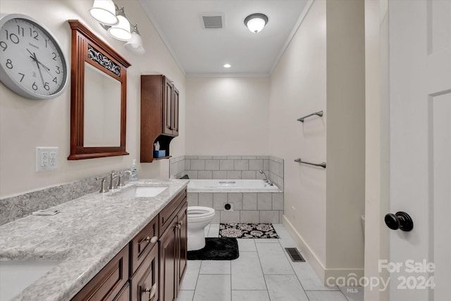 bathroom featuring tiled bath, vanity, tile patterned flooring, toilet, and crown molding