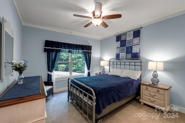 carpeted bedroom with ceiling fan and crown molding