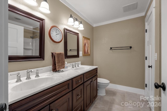 bathroom with toilet, tile patterned flooring, crown molding, and vanity