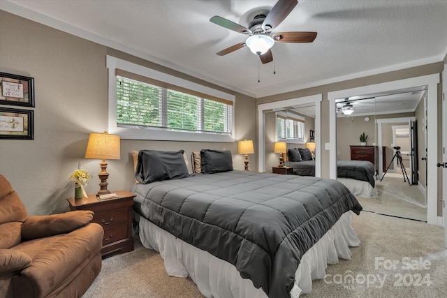 bedroom with ceiling fan, crown molding, and light carpet