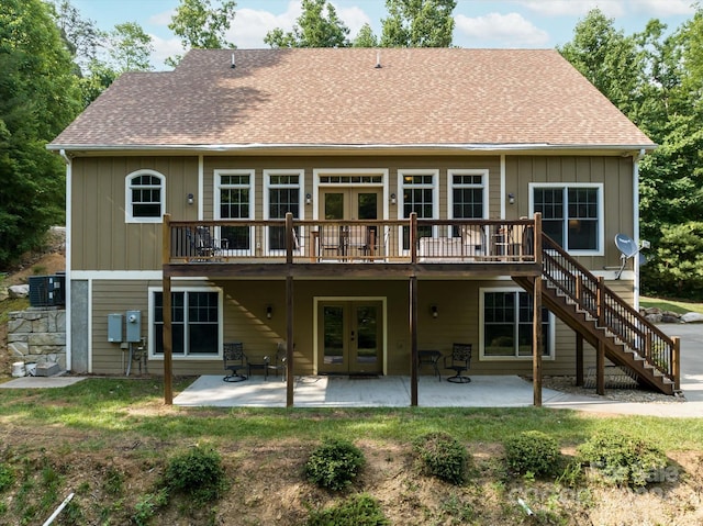 back of property with central air condition unit, french doors, a deck, and a patio