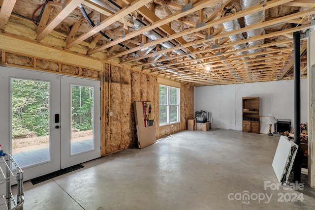 interior space with french doors, concrete floors, and plenty of natural light