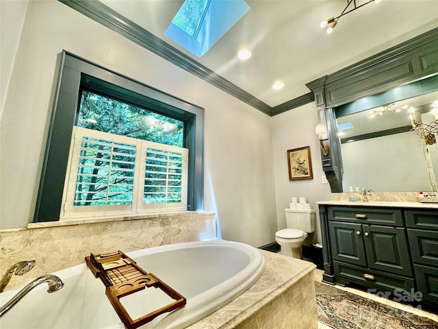 bathroom with tiled tub, vanity, a skylight, toilet, and crown molding