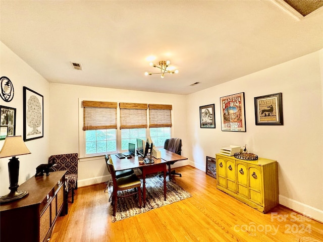 dining room with an inviting chandelier and hardwood / wood-style floors