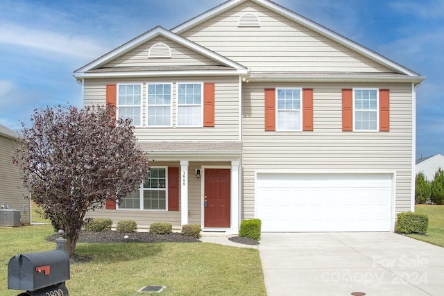 front facade featuring a garage, central air condition unit, and a front yard