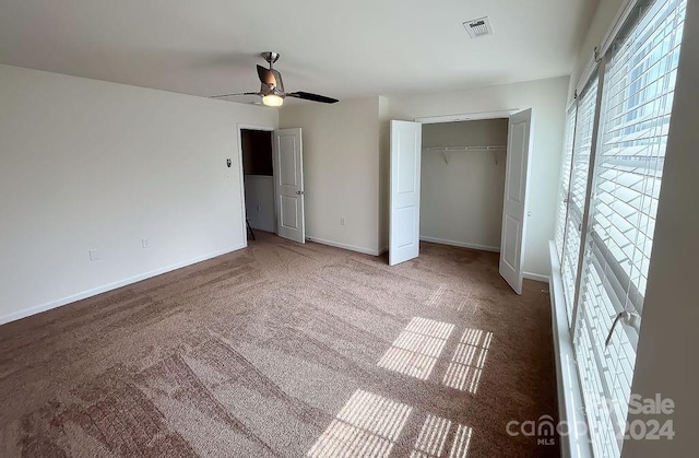 unfurnished bedroom featuring carpet flooring, ceiling fan, and a closet