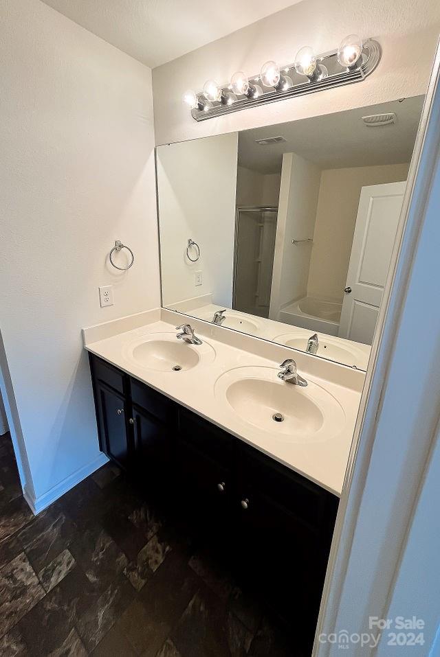 bathroom with plus walk in shower and vanity