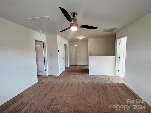 carpeted spare room with ceiling fan