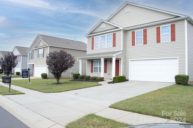 view of front of home with a garage and a front lawn