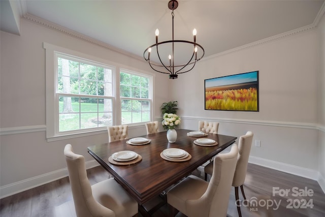 dining area featuring crown molding, dark hardwood / wood-style floors, and a notable chandelier