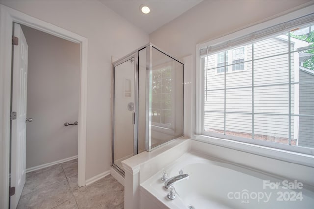 bathroom with plus walk in shower and tile patterned flooring