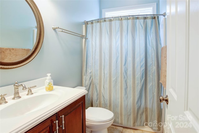 bathroom with tile patterned floors, vanity, toilet, and curtained shower