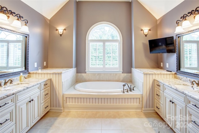 bathroom featuring tile patterned flooring, vanity, and vaulted ceiling