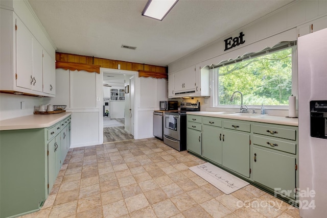 kitchen with sink, white cabinetry, white fridge with ice dispenser, green cabinets, and stainless steel electric range