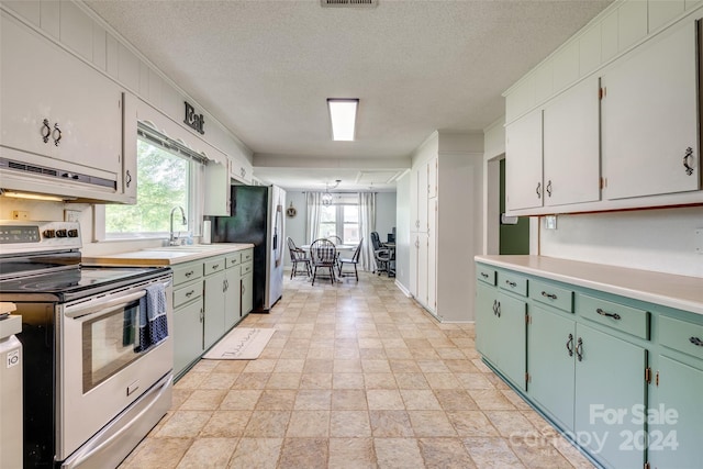 kitchen with white cabinets, sink, a textured ceiling, range hood, and appliances with stainless steel finishes