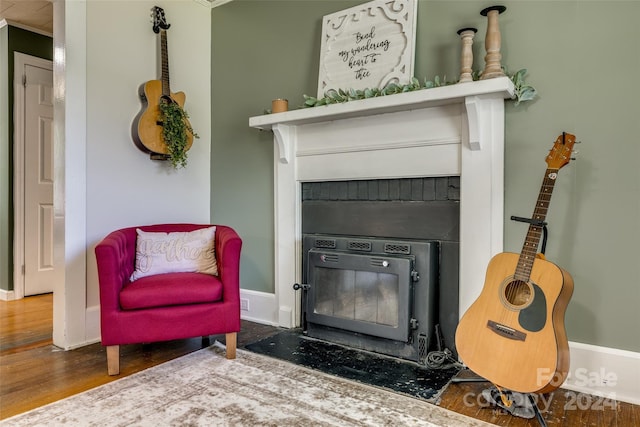 living area featuring dark hardwood / wood-style flooring and ornamental molding