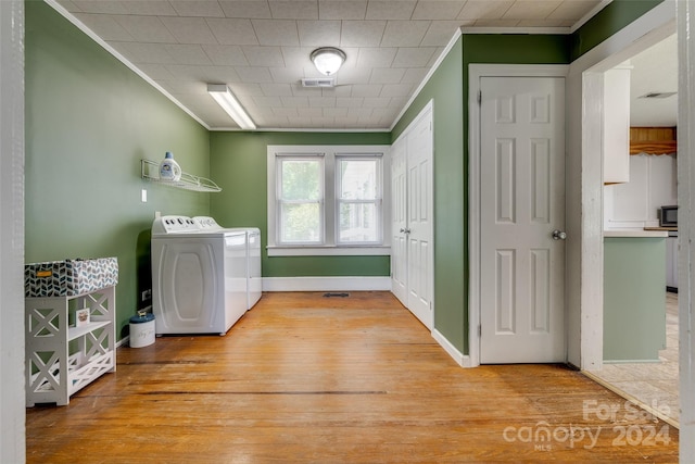 washroom with separate washer and dryer, light hardwood / wood-style floors, and ornamental molding