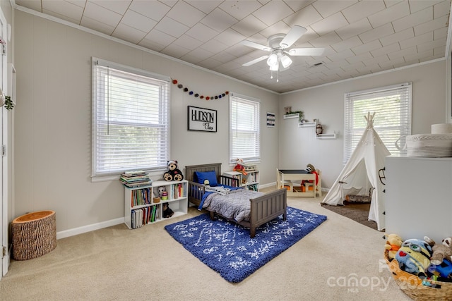 bedroom featuring ceiling fan, crown molding, and carpet