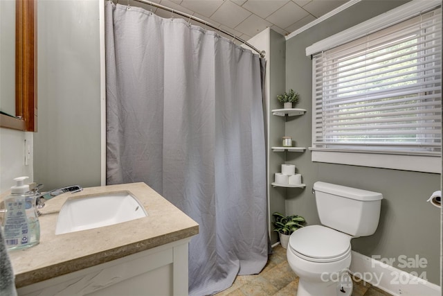 bathroom with toilet, vanity, and ornamental molding