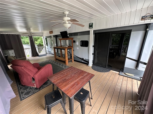 interior space with ceiling fan