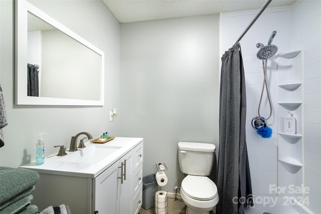 bathroom featuring vanity, toilet, and walk in shower