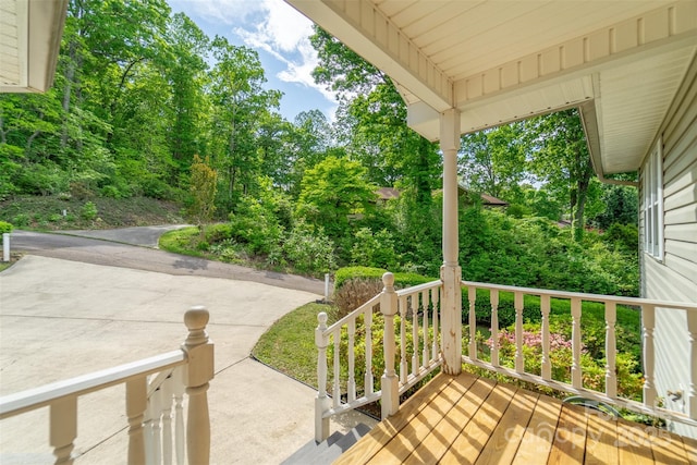 wooden deck featuring a patio area and a porch
