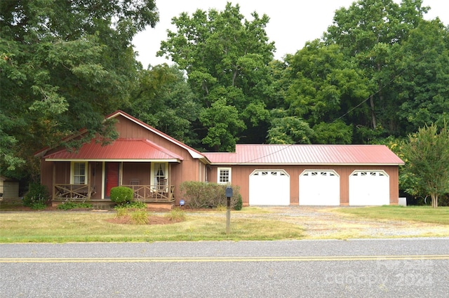 ranch-style house with covered porch, a garage, and a front lawn