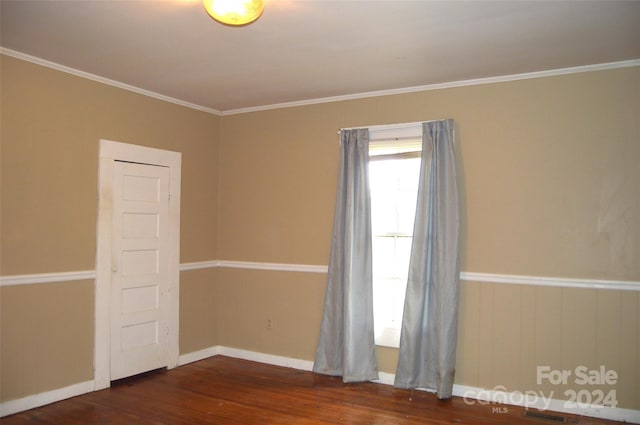 unfurnished room featuring dark hardwood / wood-style flooring and ornamental molding