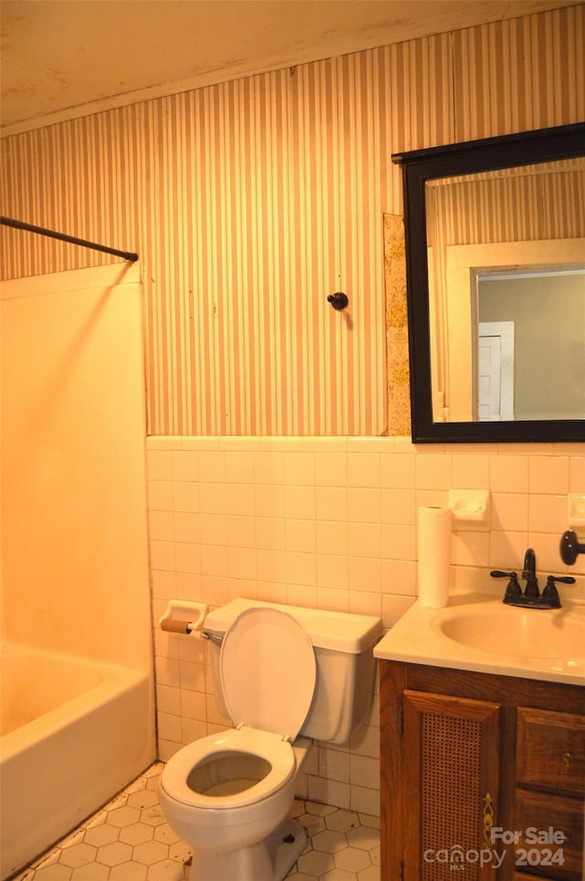 full bathroom with tile patterned flooring, toilet, and tile walls