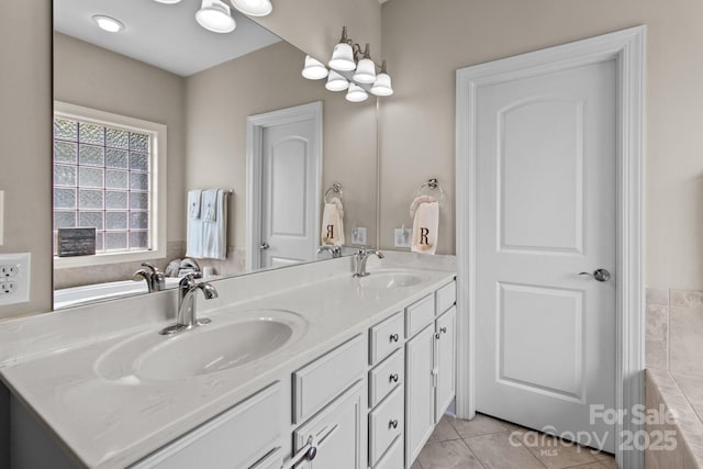 bathroom with double vanity, a sink, and tile patterned floors