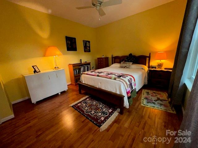 bedroom featuring ceiling fan and dark hardwood / wood-style flooring