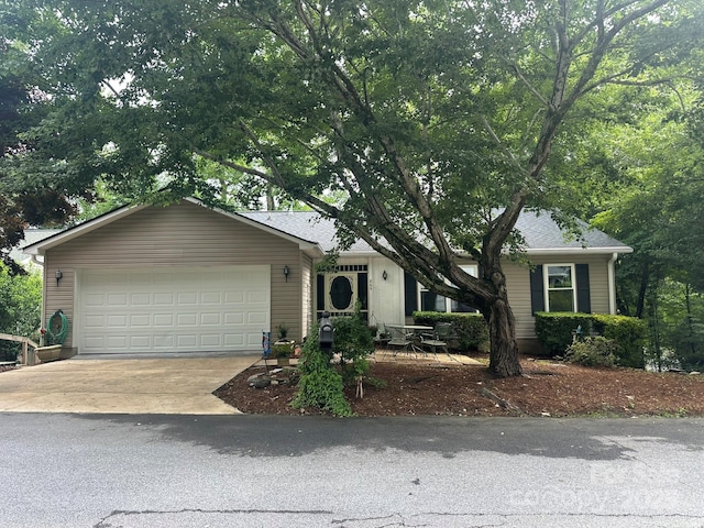 ranch-style house featuring driveway and an attached garage