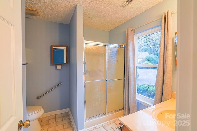 full bathroom with a wealth of natural light, visible vents, vanity, and a shower stall