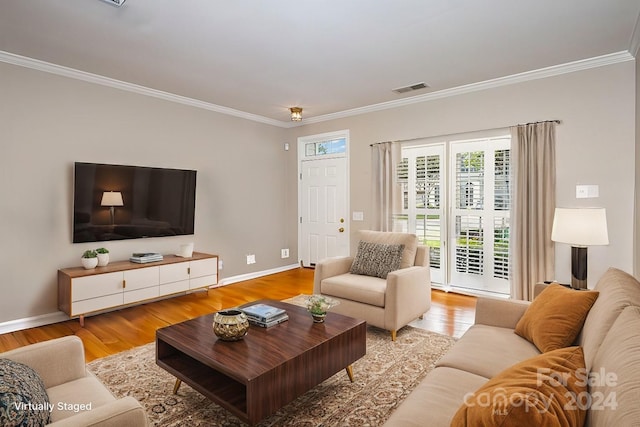 living room featuring light hardwood / wood-style flooring and ornamental molding