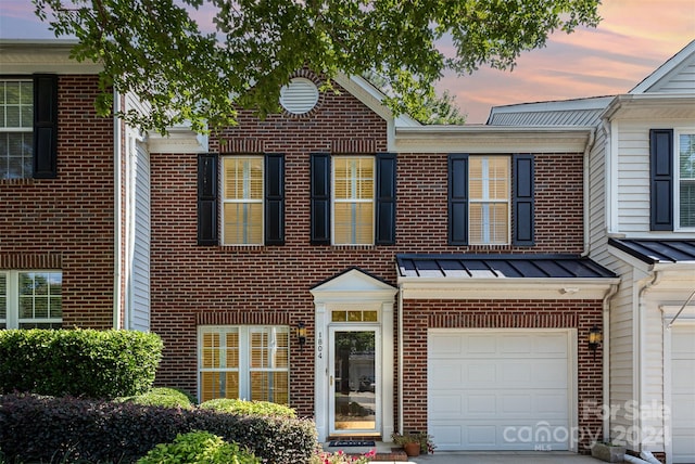 townhome / multi-family property featuring a garage