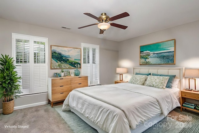 bedroom featuring ceiling fan and carpet