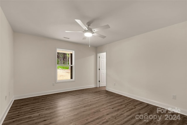 spare room with ceiling fan and dark hardwood / wood-style flooring