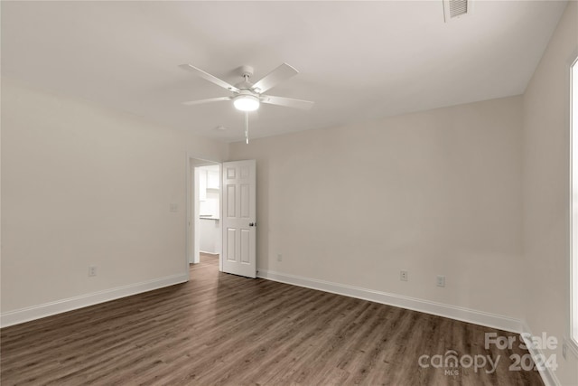 unfurnished room with ceiling fan and dark hardwood / wood-style flooring