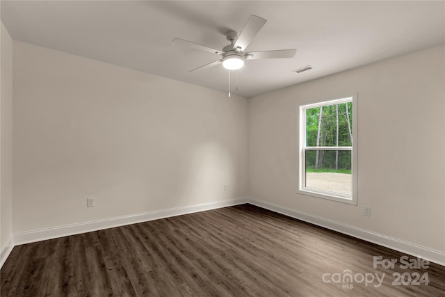 empty room featuring ceiling fan and dark wood-type flooring