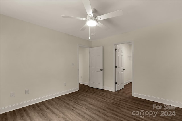 spare room featuring ceiling fan and dark wood-type flooring