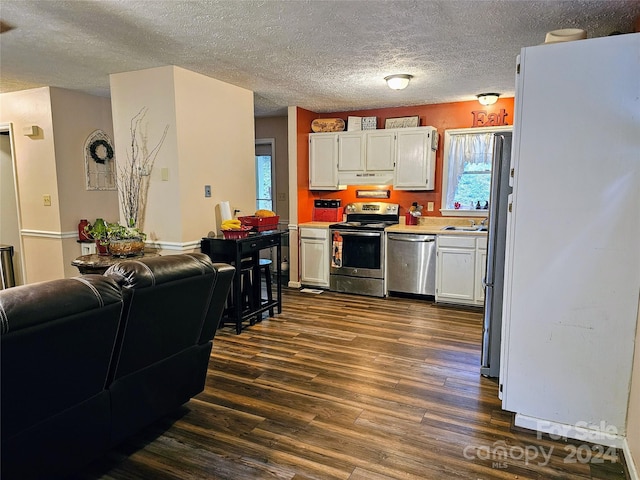 kitchen featuring dark hardwood / wood-style floors, sink, white cabinetry, a textured ceiling, and stainless steel appliances