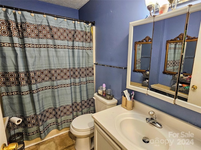 bathroom with a textured ceiling, toilet, a shower with curtain, and vanity