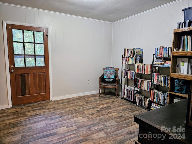 entryway featuring dark hardwood / wood-style flooring, crown molding, and a textured ceiling