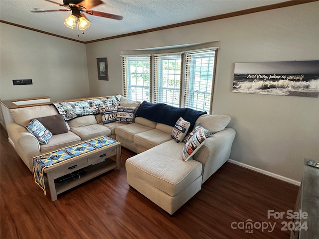 living room with a textured ceiling, dark hardwood / wood-style floors, ceiling fan, and crown molding