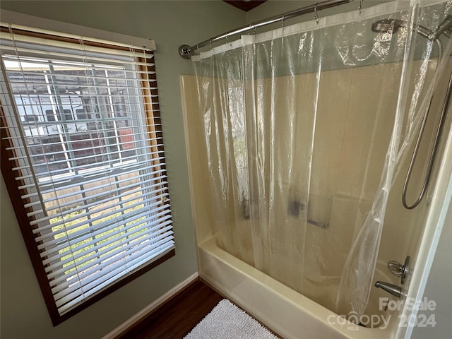 bathroom featuring hardwood / wood-style floors and shower / bath combo