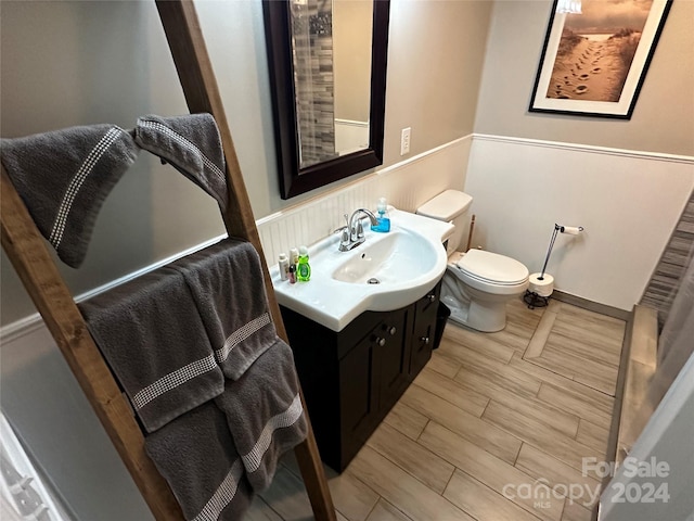 bathroom featuring hardwood / wood-style floors, vanity, and toilet