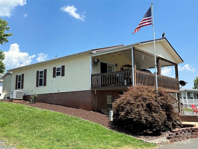 view of property exterior featuring central AC unit and a yard